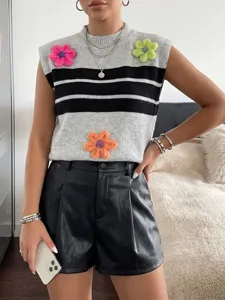 Detailed view of knit vest with colorful 3D flower appliques and chic stripes.