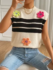 Close-up detail of stylish knit sweater vest with colorful crochet floral appliques and stripes.