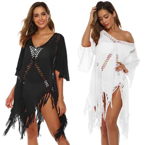 Stylish black and white crochet beach cover-up dresses featuring tassels and flare sleeves.