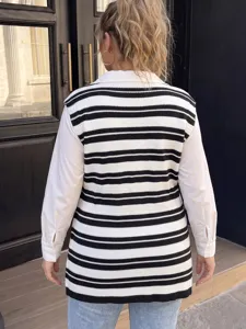 Back view of a plus-size black and white striped knit vest over a white shirt. Casual style.