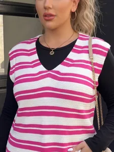 Close-up of pink and white striped V-neck knit vest over a black long sleeve top.
