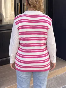 Back view detail of pink and white striped knitted vest over white long-sleeved shirt