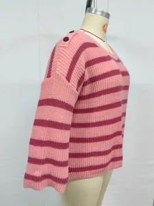 Detailed side view of a pink and brown striped knit sweater with shoulder button details.