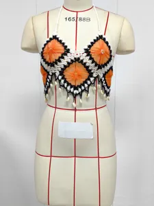 Handmade crochet halter bikini top featuring orange floral motifs and shell fringe style.