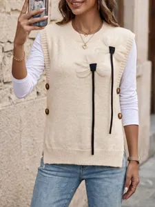 Detail view of a beige knit sweater vest featuring white 3D floral applique and side buttons