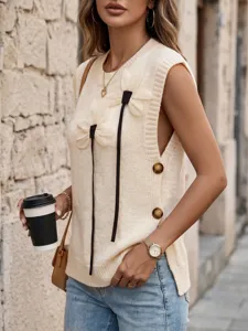 Detail view of a cream knitted vest with 3D flower appliqués and side buttons