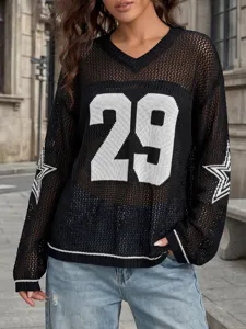 Detailopname van een zwarte gebreide mesh top met wit nummer 29 en sterren details