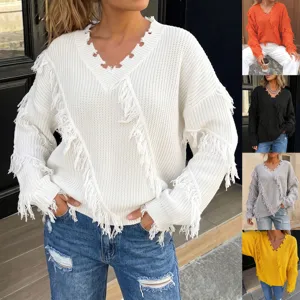 Detailed view of the stylish V-neck distressed knit sweater with playful fringe design.
