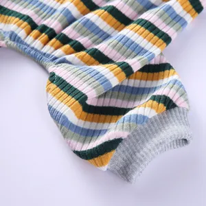 Detailed view of colorful striped dog pajamas, soft knit pet clothing sleeve and cuff.
