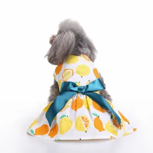 Cute white pet summer dress featuring yellow lemon prints and a large teal bow, back view