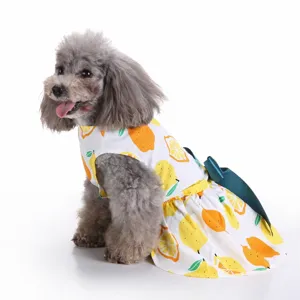 Adorable white dog dress featuring vibrant yellow lemon print and a stylish teal back bow