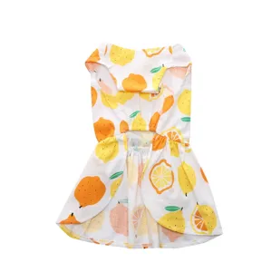 Close-up of lightweight cotton dog dress with vibrant summer lemon print pattern.
