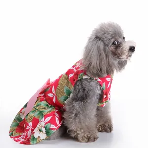 Close-up of a red floral print dog dress with a charming pink bow on a grey poodle