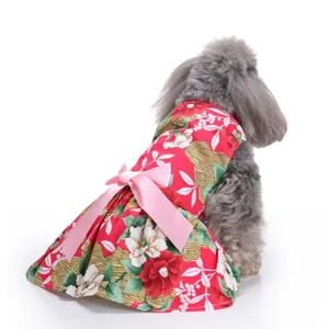 Close-up detail of a red floral print dog summer dress featuring a large pink satin bow