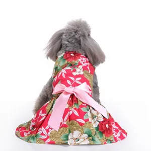 Macro detail of a vibrant red floral pet summer dress featuring a large pink bow