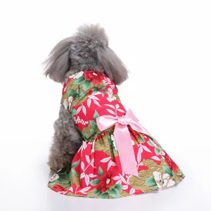 Back view of a pet wearing a vibrant red floral print dog dress with a pink satin bow.