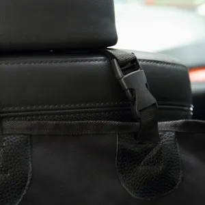 Close up detail of car pet seat cushion strap and buckle, durable black fabric design.