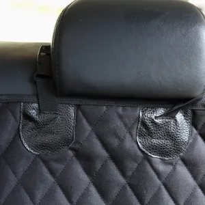 Waterproof quilted pet car seat cover detail with secure straps and headrest buckle.