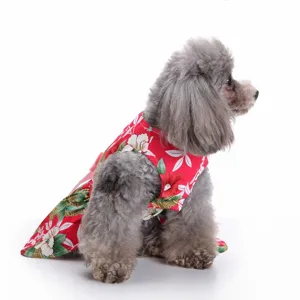 Detailed side view of a grey poodle wearing a vibrant red floral Hawaiian pet dress