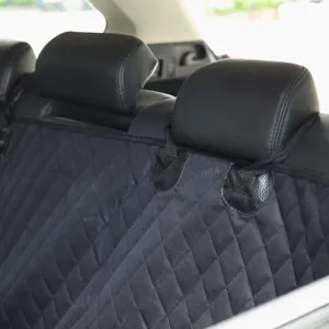 Waterproof dog car seat back cover detail, black quilted pet protector with headrest straps.