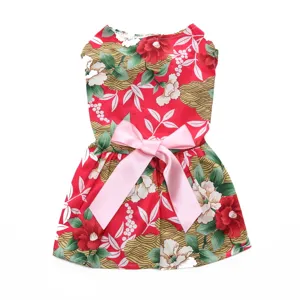 Detail view of a cute red floral pet dress featuring a large pink satin bow decoration