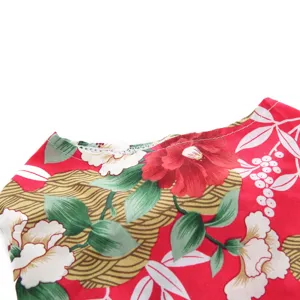 Close-up of vibrant floral print and fine stitching on a red pet summer dress