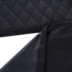 Close-up detail of black quilted pet car seat cover showing waterproof backing and velcro straps.