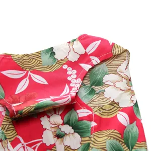 Close-up of red floral print pet dress showing collar detail and fine white stitching.