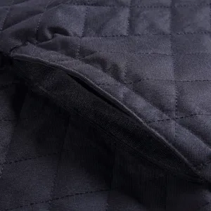 Detail shot of black waterproof quilted pet car seat cover fabric with secure velcro closure.