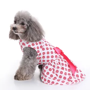 Side view detail of a white pet dog dress featuring red floral print and a pink bow