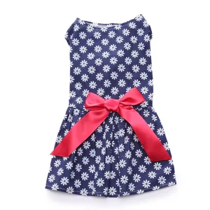 Close-up of cute navy daisy floral pet dress with a vibrant red satin bow detail.