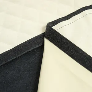 Detail view of waterproof pet car seat mat with quilted beige fabric and black non-slip backing.