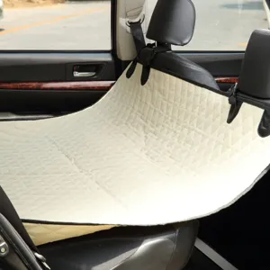 Waterproof pet car seat cover detail showing quilted beige diamond pattern in backseat.