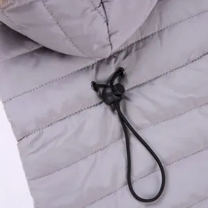 Grey quilted dog winter coat detail shot, warm pet jacket with adjustable hood and drawstring.