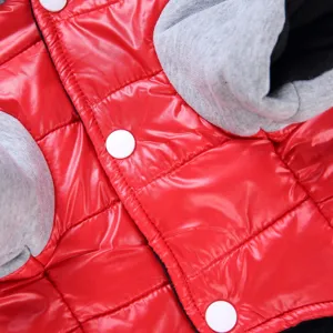 Detailed view of glossy red pet winter jacket with cozy gray hood and snap buttons.