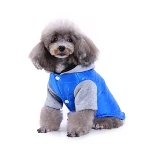 Close-up detail of warm winter pet dog clothes, blue puffer vest with grey sleeves and hood.