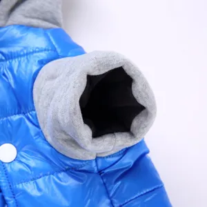 Detailed close-up of pet winter jacket sleeve, cozy fleece and warm puffer fabric design.