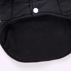Close up of black quilted pet winter jacket with warm fleece lining and snap button.