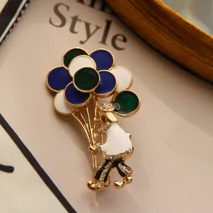 Macro view of circus clown brooch featuring colorful enamel balloons and sparkling rhinestones.
