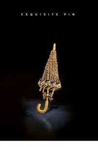 Close-up of golden umbrella brooch with shimmering champagne crystals and bow detail