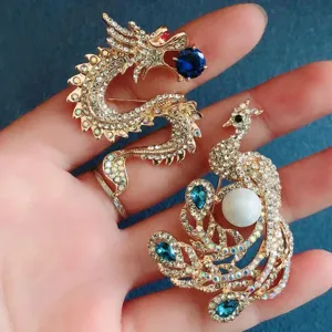Close-up of vintage dragon and phoenix brooches with sparkling rhinestones and blue gems