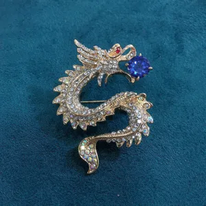 Detailed view of a vintage dragon brooch with sparkling white and blue rhinestones