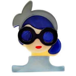 Close-up detail of a stylized acrylic girl brooch featuring blue hair and sunglasses.