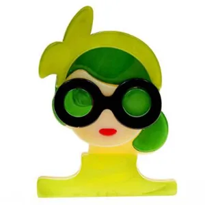 Detailed close-up of a quirky acrylic brooch featuring a girl wearing big round sunglasses