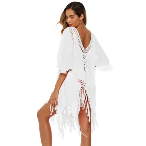 Detailed view of white crochet back beach cover-up with tassels and flare sleeves