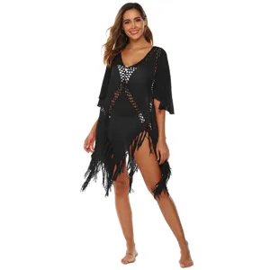 Sexy black crochet beach cover-up with tassels and flared sleeves for bikini layering.