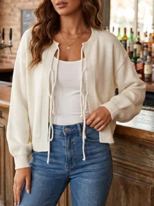 Close-up detail of the elegant white lace-up knit cardigan featuring soft texture and chic style.