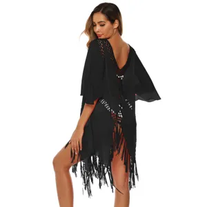 Back view of black crochet beach cover-up dress with fringe and bell sleeves