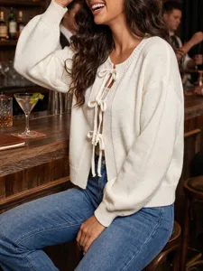 Cozy round neck tie front knit cardigan paired with classic blue jeans for women stylish look.