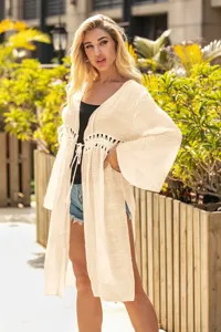 Detailed view of cream crochet hollow-out cardigan with bell sleeves and drawstring waist